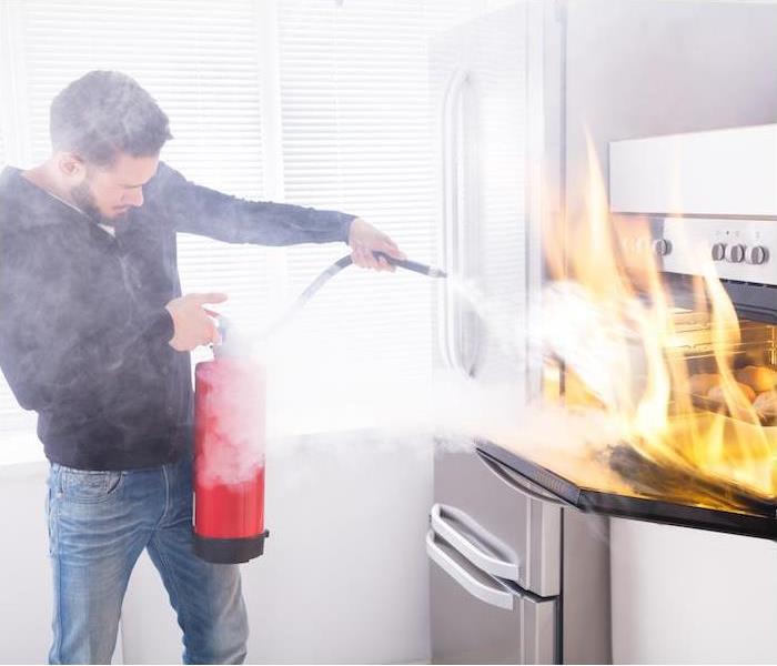 man putting out kitchen fire