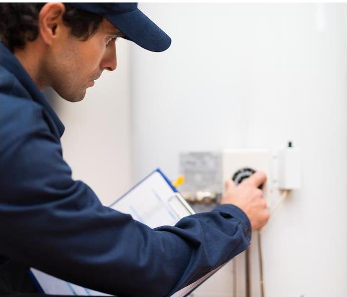 man inspecting water controls
