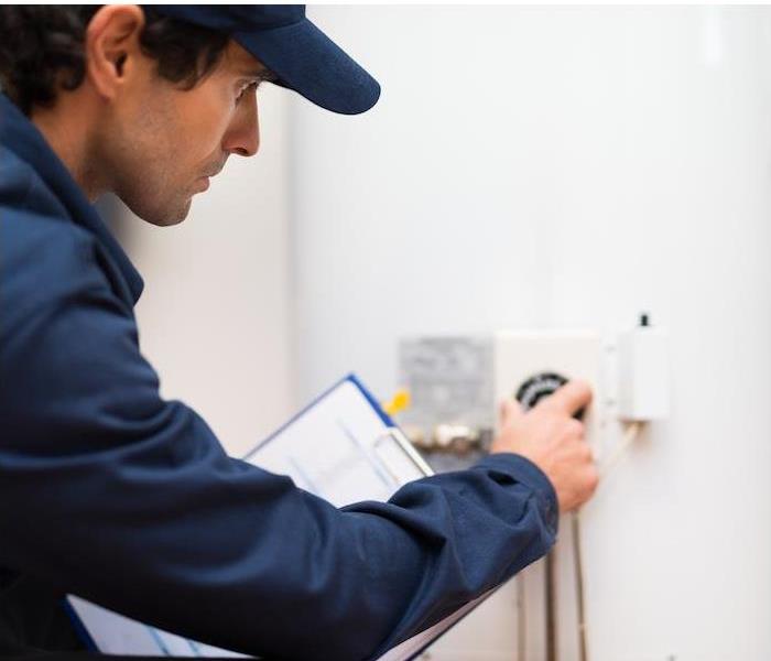guy checking the thermostat